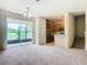 Living room with kitchen and access to screened patio at 2543 Old Kent Cir, Kissimmee, FL 34758