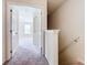 Upstairs hallway with carpet and doors to bedrooms at 2543 Old Kent Cir, Kissimmee, FL 34758