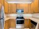 Clean kitchen, stainless steel appliances and wood cabinets at 2543 Old Kent Cir, Kissimmee, FL 34758