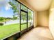 Screened porch with view of lake and lush greenery at 2543 Old Kent Cir, Kissimmee, FL 34758