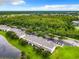 Aerial view showcasing townhouses and a tranquil lake at 2543 Old Kent Cir, Kissimmee, FL 34758