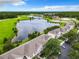 Aerial view of community with lake, pool, and walking path at 2543 Old Kent Cir, Kissimmee, FL 34758