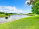 Serene lake view with lush green landscape and blue skies at 2543 Old Kent Cir, Kissimmee, FL 34758