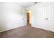 Bedroom with double doors and access to bathroom at 2543 Old Kent Cir, Kissimmee, FL 34758