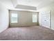 Bright bedroom with carpeted floor and tray ceiling at 2543 Old Kent Cir, Kissimmee, FL 34758