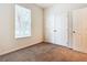 Bright bedroom with a window, double door closet and carpet at 2543 Old Kent Cir, Kissimmee, FL 34758