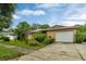 Single story home with attached garage and nicely landscaped yard at 1759 Tallo Way, Orlando, FL 32818