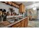 Kitchen with double sink, wood cabinets and granite countertops at 1759 Tallo Way, Orlando, FL 32818