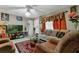 Living room with tiled floors, beige couch, and two armchairs at 1759 Tallo Way, Orlando, FL 32818