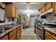 Kitchen with wood cabinets, granite countertops, and stainless steel appliances at 1759 Tallo Way, Orlando, FL 32818