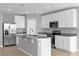 Modern kitchen with white cabinets, granite countertops, and stainless steel appliances at 531 Tortugas St, Haines City, FL 33844