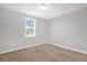Simple bedroom with neutral walls, carpet flooring, and window with blinds at 531 Tortugas St, Haines City, FL 33844