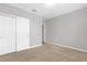 Bedroom with carpet flooring, double door closet, and access to another room at 531 Tortugas St, Haines City, FL 33844