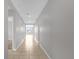 Long hallway with tile flooring and doors to other rooms at 531 Tortugas St, Haines City, FL 33844
