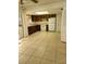 Functional kitchen with wood cabinets and tiled floor at 2222 Silver Pines Pl # 902, Orlando, FL 32808