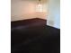Large living room with dark carpet and plenty of natural light at 2222 Silver Pines Pl # 902, Orlando, FL 32808