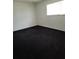Bright bedroom featuring dark carpeting and a window at 2222 Silver Pines Pl # 902, Orlando, FL 32808