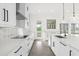 Open kitchen with white cabinets, stainless steel appliances and backyard access at 13839 Larkton Ln, Orlando, FL 32832