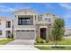 Two-story house with a gray exterior, two-car garage, and landscaping at 13839 Larkton Ln, Orlando, FL 32832