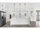 Modern kitchen with white cabinets, large island, and stainless steel appliances at 13839 Larkton Ln, Orlando, FL 32832