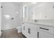 Clean bathroom with a walk-in shower, white vanity, and gray tile floor at 13839 Larkton Ln, Orlando, FL 32832