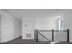 Bright hallway with grey carpet and a modern staircase at 13839 Larkton Ln, Orlando, FL 32832