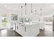 Modern kitchen with white cabinets, island, stainless steel appliances, and backyard view at 13839 Larkton Ln, Orlando, FL 32832