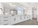Modern bathroom with double vanity, white cabinets, and black hardware at 13839 Larkton Ln, Orlando, FL 32832