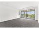Spacious bedroom with gray carpeting and sliding glass doors opening to a balcony at 13839 Larkton Ln, Orlando, FL 32832