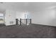 Open loft space featuring a modern staircase and grey carpet at 13839 Larkton Ln, Orlando, FL 32832
