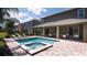 Relaxing private pool and spa with patio seating and lush landscaping at 751 Lasso Dr, Kissimmee, FL 34747