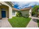 One-story home with blue door and lush landscaping at 4028 Navigator Way, Kissimmee, FL 34746