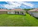 Spacious backyard with large grassy area and covered patio at 4028 Navigator Way, Kissimmee, FL 34746