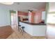 Open kitchen with stainless steel appliances and breakfast bar at 4028 Navigator Way, Kissimmee, FL 34746