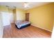 Bedroom with wood floors, ceiling fan, and access to bathroom at 4028 Navigator Way, Kissimmee, FL 34746