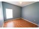 Light-filled bedroom with wood-look floors and neutral walls at 4028 Navigator Way, Kissimmee, FL 34746