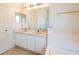 Bathroom with double sinks and a tub at 4028 Navigator Way, Kissimmee, FL 34746