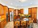 Spacious kitchen with an island, wood cabinets, and stainless steel appliances at 8734 Crestgate Cir, Orlando, FL 32819