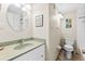 Clean bathroom with a toilet, sink, and shower at 335 N Causeway # B010, New Smyrna Beach, FL 32169