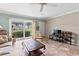 Living room with tile floors, comfortable seating, and sliding glass doors at 335 N Causeway # B010, New Smyrna Beach, FL 32169