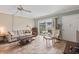 Living room features tile floors, comfortable furniture, and access to a patio at 335 N Causeway # B010, New Smyrna Beach, FL 32169