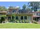 Back exterior view showcasing a deck and landscaping at 437 Oak Haven Dr # 437, Altamonte Springs, FL 32701