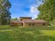 Ranch-style home with brick exterior, large yard, and mature trees at 9525 Mcnorton Rd, Altamonte Springs, FL 32714
