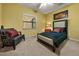 Cozy bedroom with a twin bed, window, and a comfortable armchair at 9525 Mcnorton Rd, Altamonte Springs, FL 32714