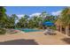 Alt text: Community swimming pool with lounge chairs and patio tables at 1150 Carmel Cir # 408, Casselberry, FL 32707