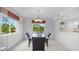 Bright dining room with glass table and neutral decor at 1150 Carmel Cir # 408, Casselberry, FL 32707