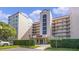 Exterior view of a condo building with landscaping and parking at 1150 Carmel Cir # 408, Casselberry, FL 32707