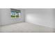 Spacious bedroom with neutral carpeting and a window offering natural light at 1150 Carmel Cir # 408, Casselberry, FL 32707