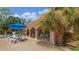 Alt text: Pool area with tables, chairs, and umbrellas at 1150 Carmel Cir # 408, Casselberry, FL 32707