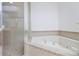 Bathroom features a corner soaking tub, shower, and tile flooring at 8712 The Esplanade # 19, Orlando, FL 32836